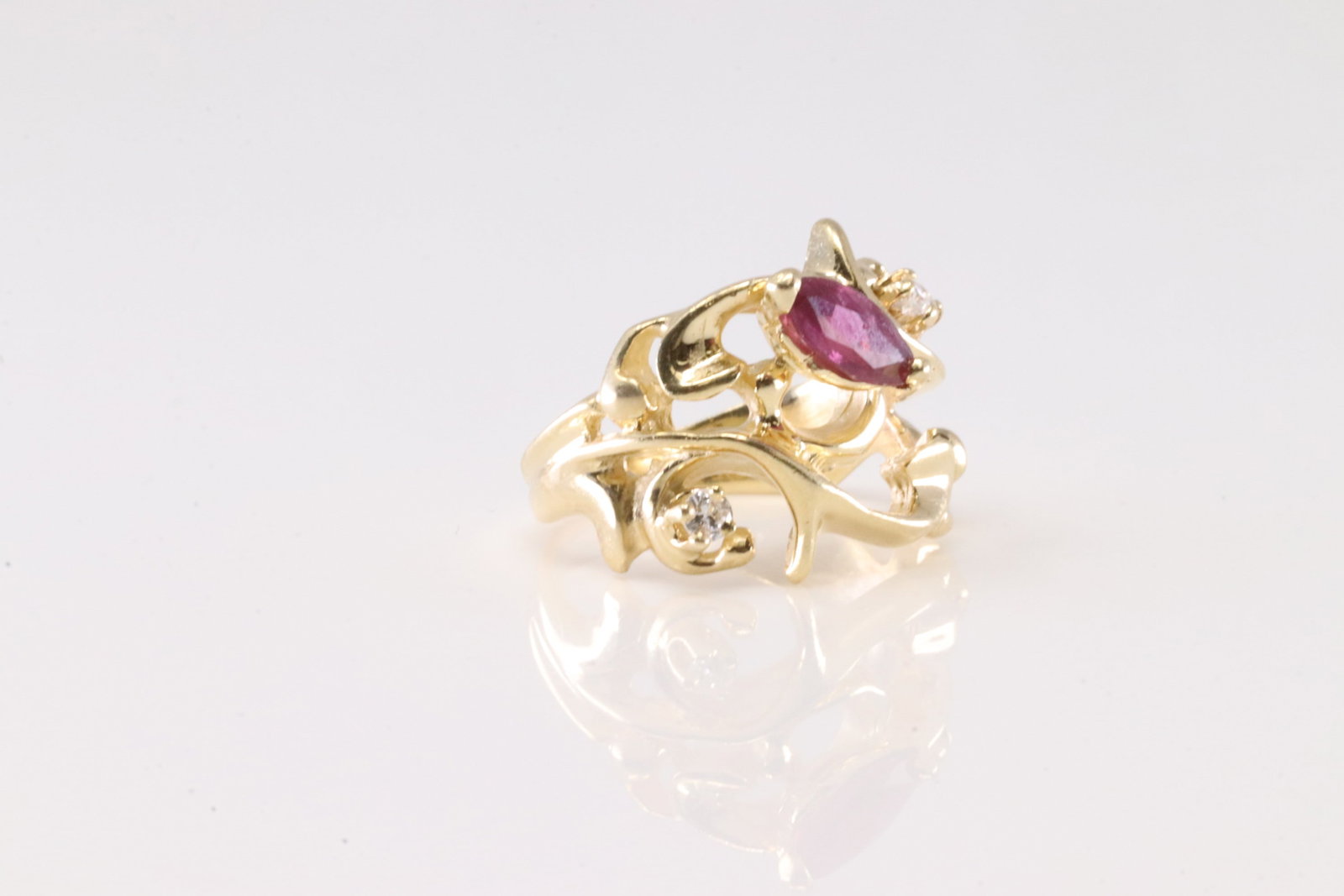 Ruby & Diamond Ring 14Kt.: Ladies 14Kt Yellow Gold Ruby & Diamond Ring. This ring has an design with one marquise ruby and 2 round diamonds. Ring size: 2.00. Total weight: 3.80 Grams.