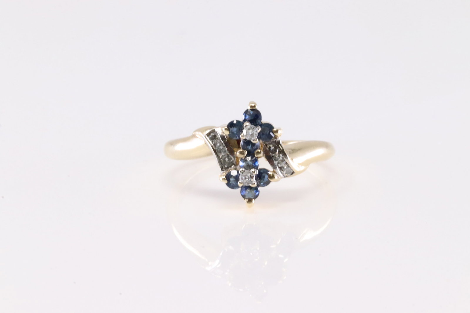 Sapphire & Diamond Ring 10Kt.: Ladies 10Kt Yellow Gold Sapphire & Diamond Ring. This Charming Ring has Flower Design with Sapphires And Sparkling Diamonds. Ring size: 5.75. Total weight: 2.65 Grams.