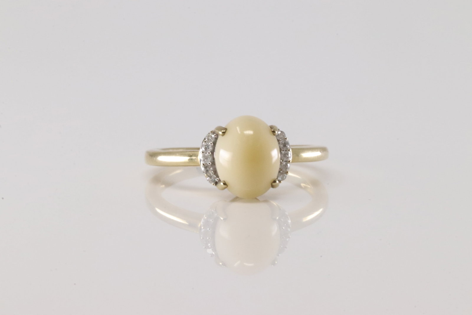 Opal & Diamond Ring 10Kt.: Ladies 10Kt Yellow Gold Opal & Diamond Ring. This Ring has Oval Opal with 10 Round Diamonds. Diamonds weight: 0.07ctw. Ring size: 7.00. Total weight: 2.30 Grams.