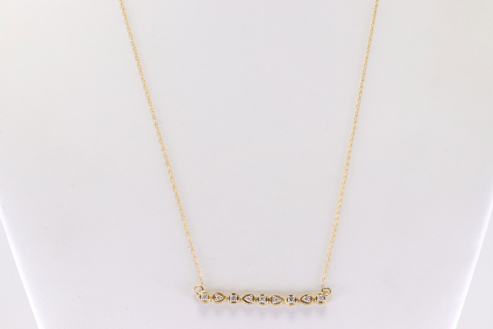 Diamond Necklace 10Kt.: Ladies 10Kt Yellow Gold Diamond Necklace. This Gorgeous Necklace has 9 Round Sparkling Diamonds. Diamond Approx Weight: 0.15 ctw. Necklace Length: 18.00. Total Weight: 1.60 Grams.