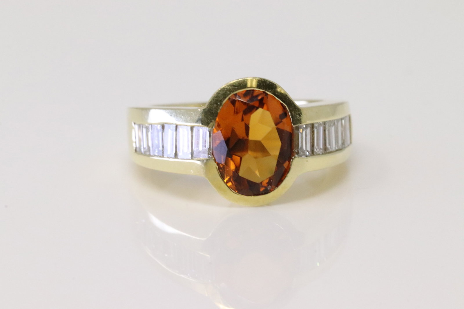 Citrine & Diamond Ring 18Kt.: 18Kt Yellow Gold Citrine & Diamond Ring. Ring has Oval Citrine Gemstone with 12 Cut Baguette Diamonds. Diamonds weight approx: 1.25cw.Ring size: 5.25. Total weight: 10.30 Grams.