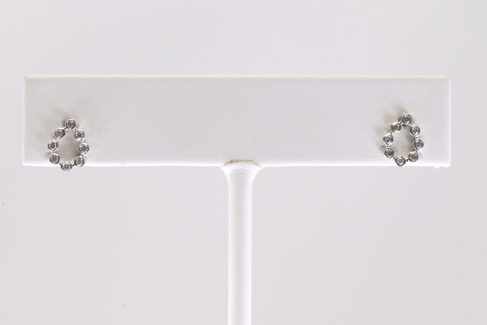 Diamond Stud Earring 14Kt.: Ladies 14Kt White Gold Diamond Stud Earring. Earrings feature a delicate circular design, perfect for adding a touch of sophistication to any outfit. The 16 sparkling Diamonds are set in a sleek Gold