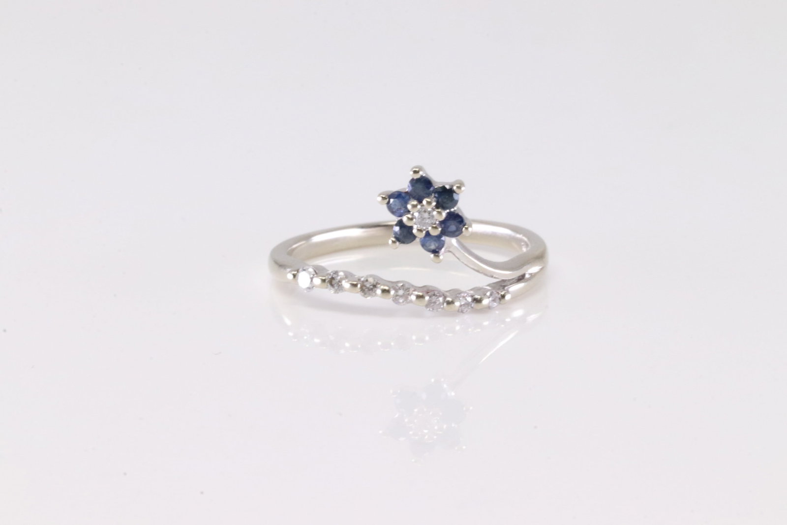 Sapphire & Diamond Ring 14Kt.: Ladies 14Kt White Gold Sapphire & Diamond Ring. This Charming Ring has Flower Design with Sapphires And Sparkling Diamonds. Ring size: 6.25.