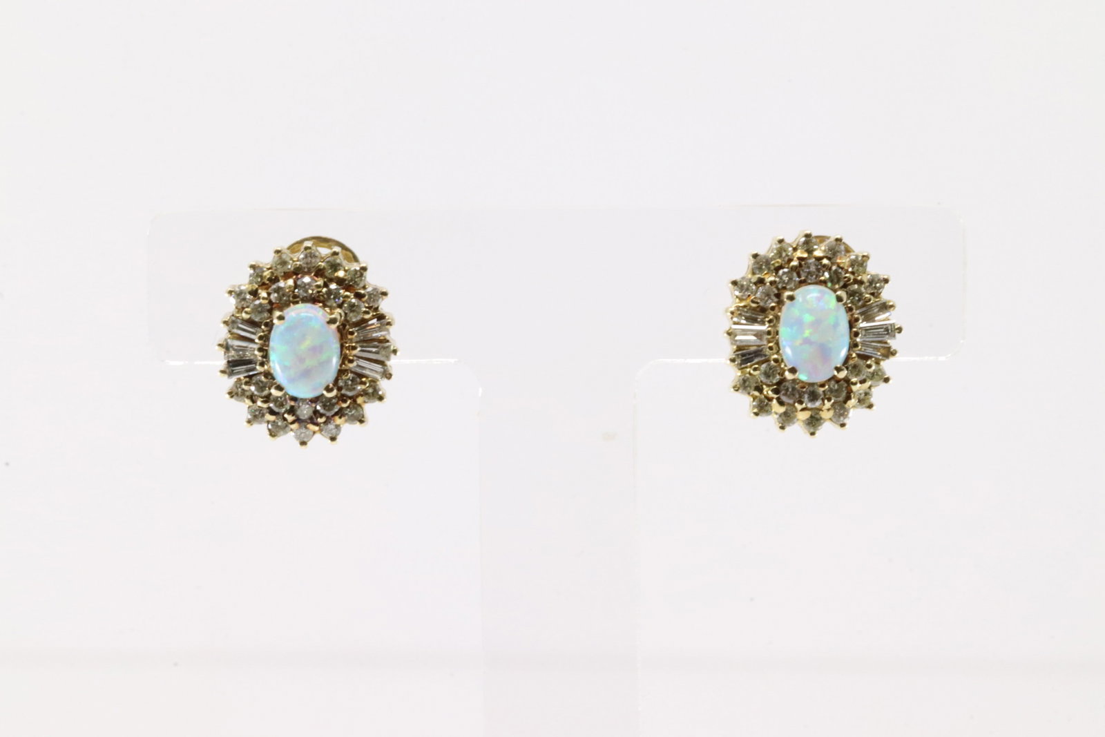 Elegant Opal & Baguette Diamond Stud Earring 14Kt.: Ladies 14Kt Yellow Gold Opal & Baguette Diamond Stud Earring. This elegant stud erring has white oval opal on the center with 60 round & baguette diamonds. Diamonds weight approx: 1.50 ctw Total
