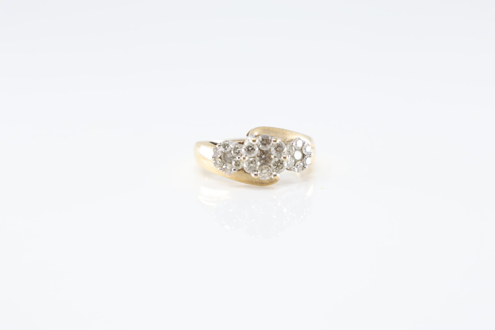 Diamond Ring 10Kt.: Ladies 10Kt Yellow Gold Diamond Ring. This Ring has 3 flower design setting with 7 round diamonds set on each , making a total of 21 round diamonds. Diamonds weight approx: 1.00cttw.Ring size: 7.00.