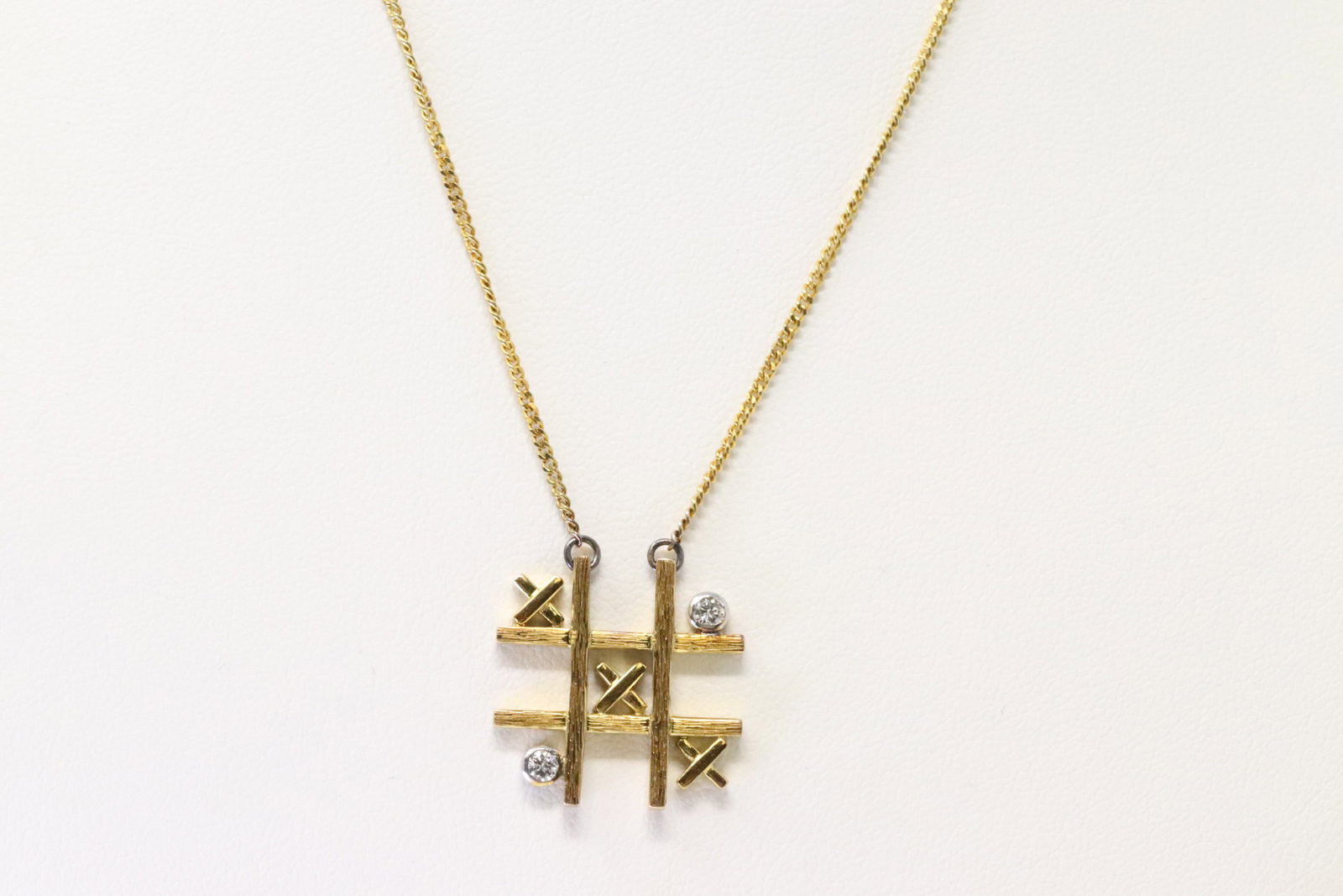 Diamond Necklace 14Kt.: 14Kt Yellow Gold Diamond Necklace. Necklace has Pendant with X & 2 Diamonds. Necklace length: 14.00" Total weight: 6.50 Grams.