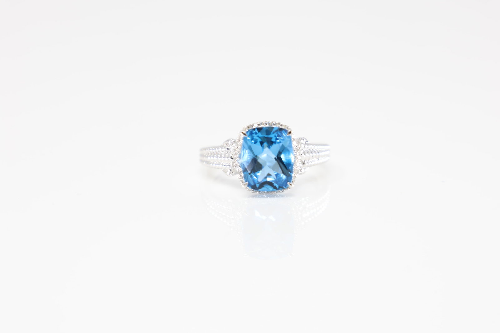 Blue Topaz & Diamond Ring 14Kt.: 14Kt White Gold Blue Topaz & Diamond Ring. This Ring has Cut Blue Topaz surrounded by approx 50 sparkling round diamonds. Diamonds weight approx:0.35ctw. Ring size: 7.00. Total weight: 4.70 Grams.