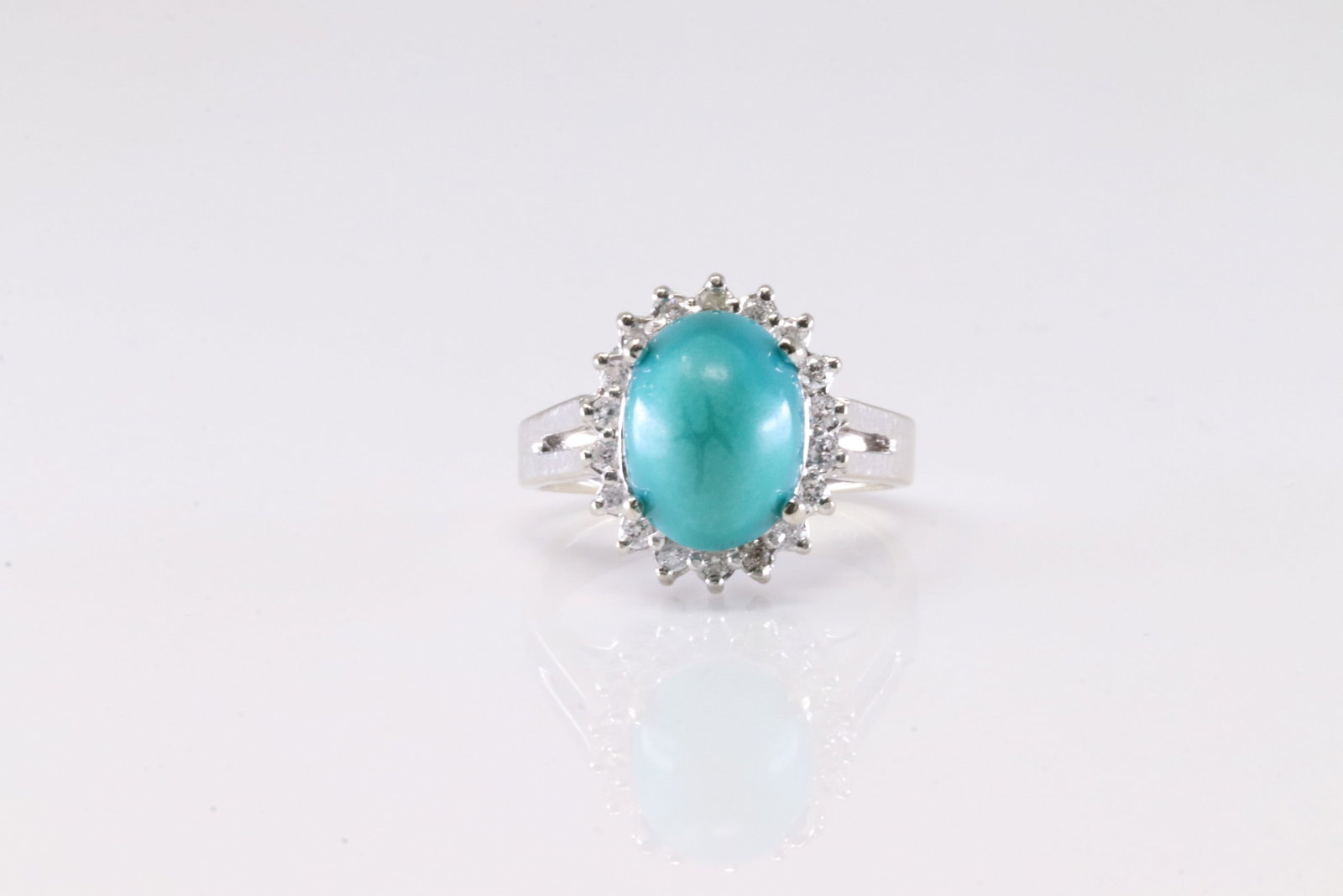 Turquoise & Diamond Ring 14Kt.: Ladies 14Kt White Gold Turquoise & Diamond Ring. This Elegant Ring has Turquoise Stone Surrender By 18 Sparkling Diamonds. Ring size: 6.00. Total weight: 6.15 Grams.