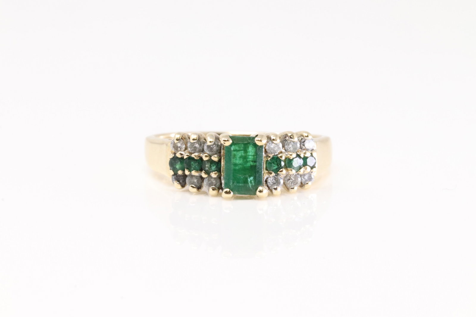 Emerald & Diamond Ring 14Kt.: Ladies 14Kt Yellow Gold Emerald & Diamond Ring. This Ring has 7 Gorgeous Emerald Gemstones With 12 Round Sparkling Diamonds. Ring Size: 6.50. Total Weight: 3.60 Grams.