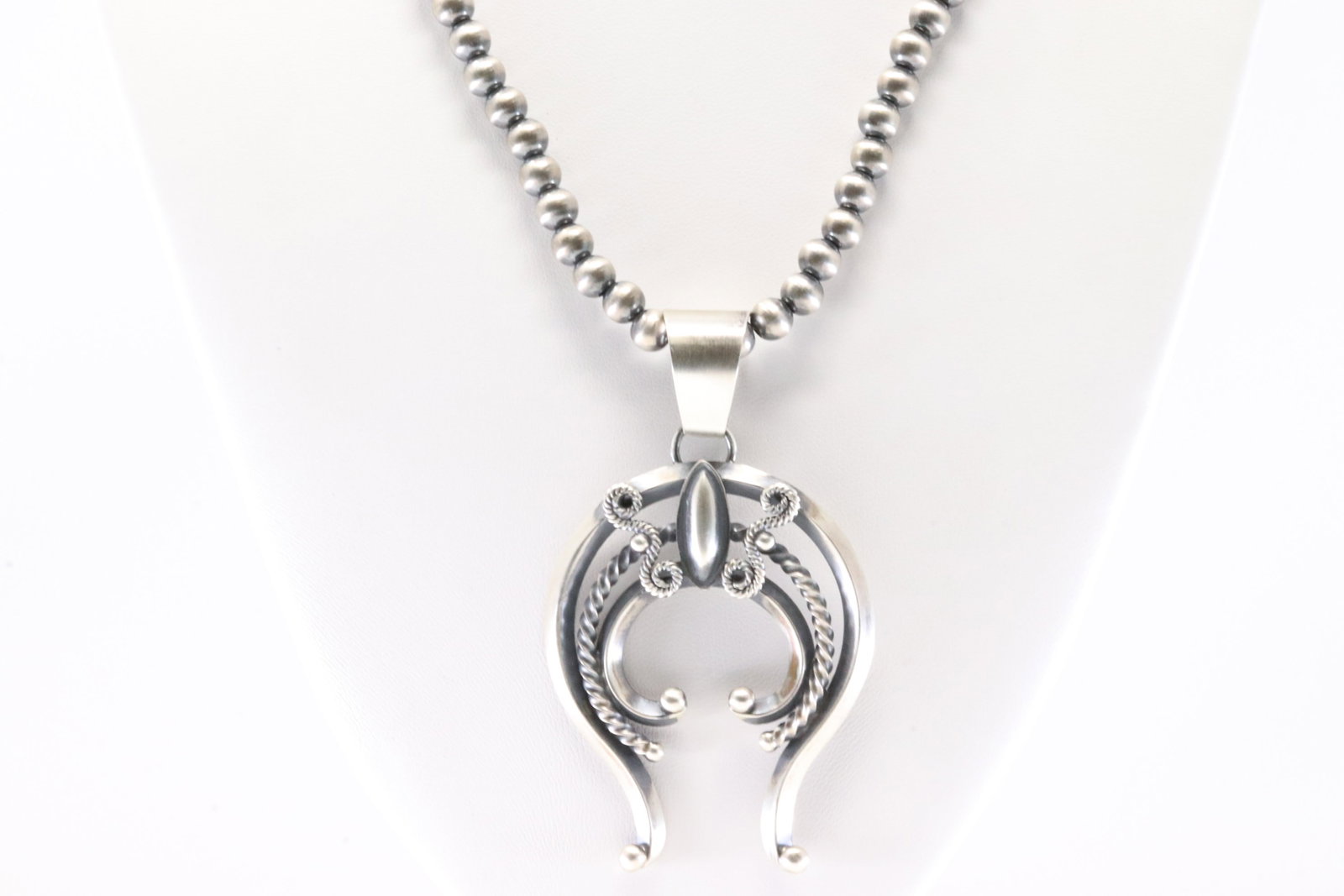Native America Navajo Sterling Silver Naja Pendant By Frrick With Machine Made Stearling Silver: This is a Native America Navajo Sterling Silver Naja Pendant By Frrick With Machine Made Stearling Silver Pearl Beaded Necklace. Necklace length: 18.00"