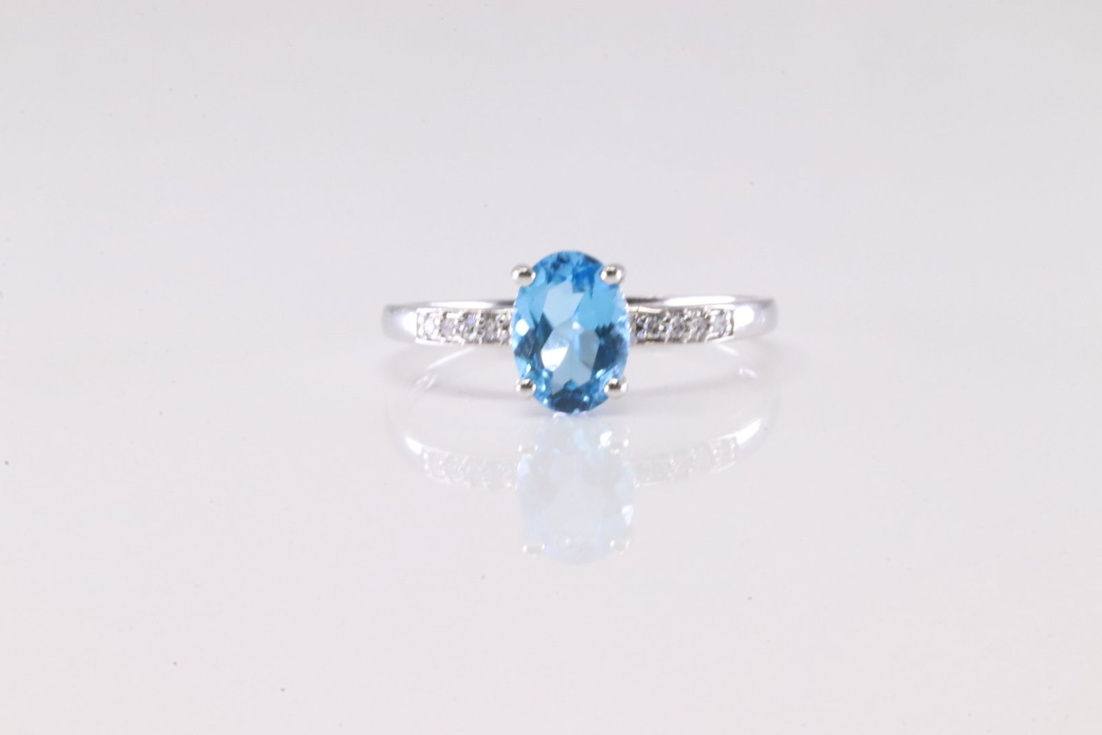 Blue Topaz & Diamond Ring 14Kt.: 14Kt White Gold Blue Topaz & Diamond Ring. This Charming Ring has Blue Topaz Gemstone with Sparkling Diamonds to the sides. Diamonds weight approx: 0.15ctw. Ring size: 7.00.