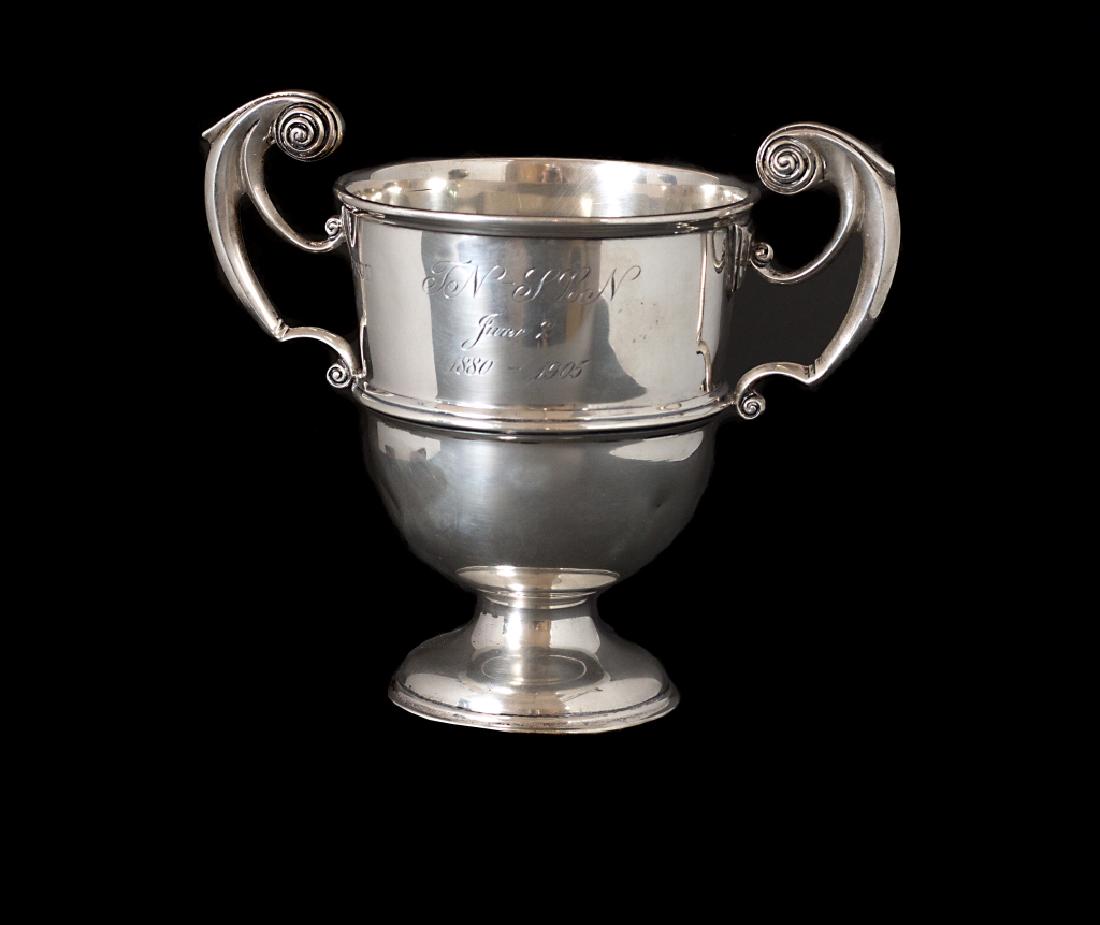 An Edward VII silver two handled cup: Charles Stuart Harris, London, 1904 With crest and presentation inscription: TN - SLN, June 2, 1880-1905 5 ¾ in. H (9 oz. 8 dwts.) (GMP no#)