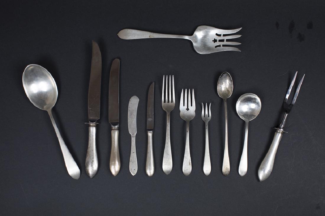 A sterling partial flatware set: Dominick & Haff, New York, NY Pointed Antique Comprising: 11-7 ¼ in forks, 12 salad forks, 12 cocktail forks, 4 teaspoons, 11 iced beverage spoons, 12 soup spoons, 2 pc salad serving set: fork and sp