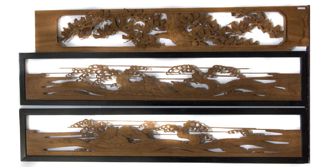 A group of Japanese transom panels, or ranma: Two carved with a tortoise floated on ebbing waves; one carved with cypress boughs, the fourth leafed bamboo stalks, together with a Chinese gilt peony carved example. Greatest length 73in.