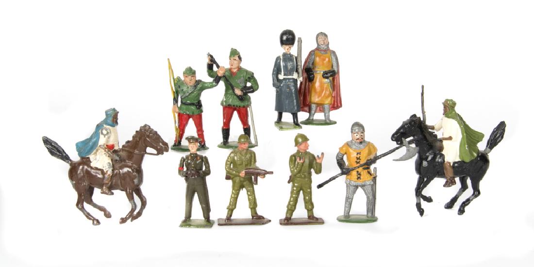 A group of toy soldiers: Including English and Scottish soldiers, knights, artillery soldiers, guardsmen, a Trojan warrior, Arabians on horseback, archers and accessories including trees, deer, a canon, a guard house, etc. So