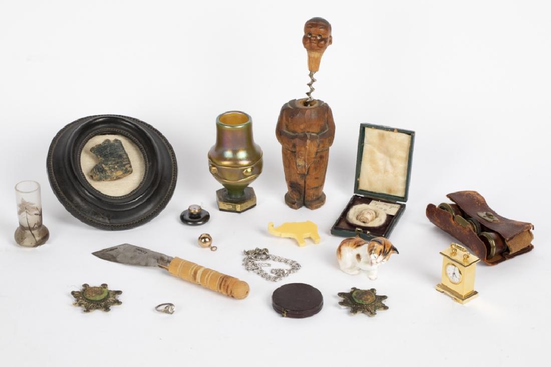 A group of decorative objects: Including a miniature iridescent glass vase on plinth, a small hand painted glass vase, a set of opera glasses with case, a Royal Doulton cat, a French honorable mention medal, a pair of British badge