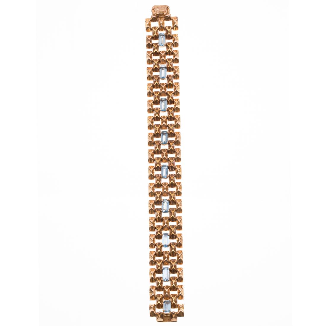 A Retro 14k rose gold, synthetic spinel bracelet: Featuring nine rectangular step-cut synthetic spinels, each measuring approximately 8.0 x 4.0 mm, set in a 14k rose gold textured brick link mounting secured by a tongue and groove clasp with two figu