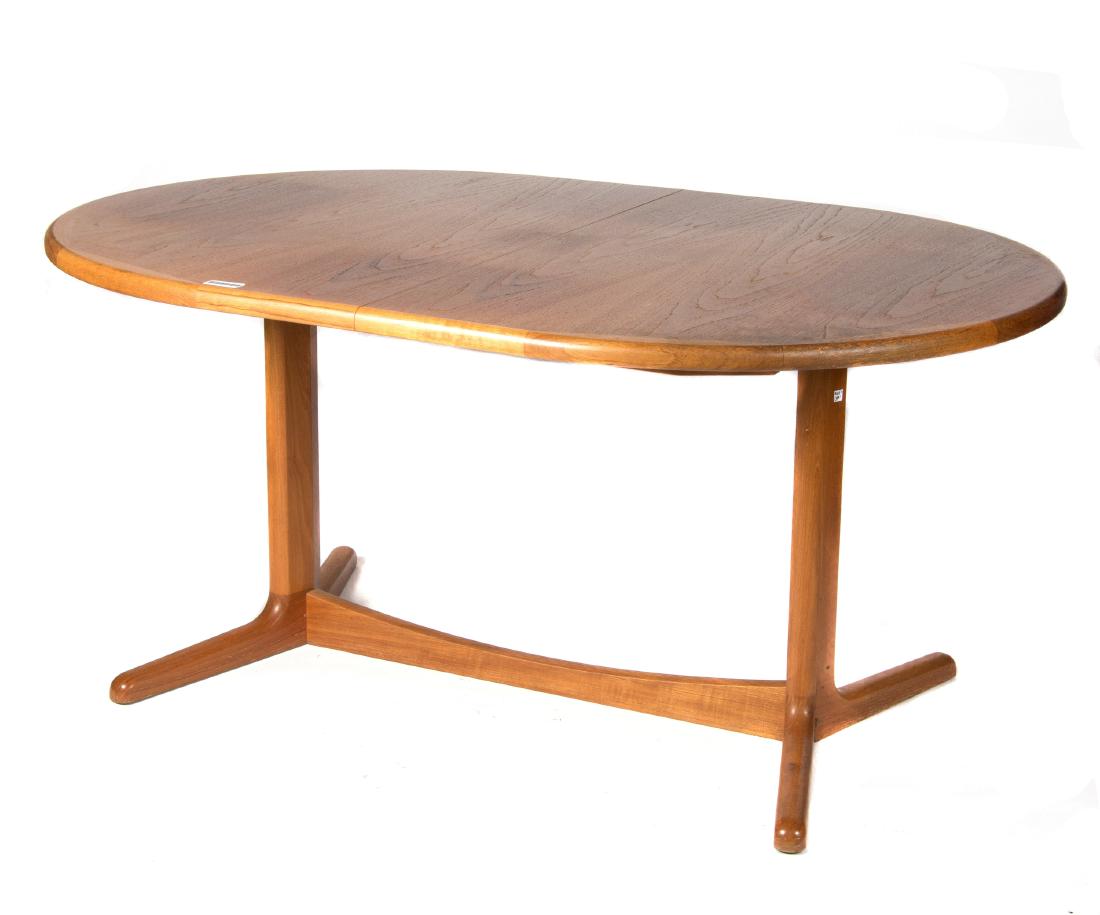 Contemporary Scandinavian teak dining table: Mid 20th century. The oval top on V-form supports. 28in. H x 42in. W x 61in. L