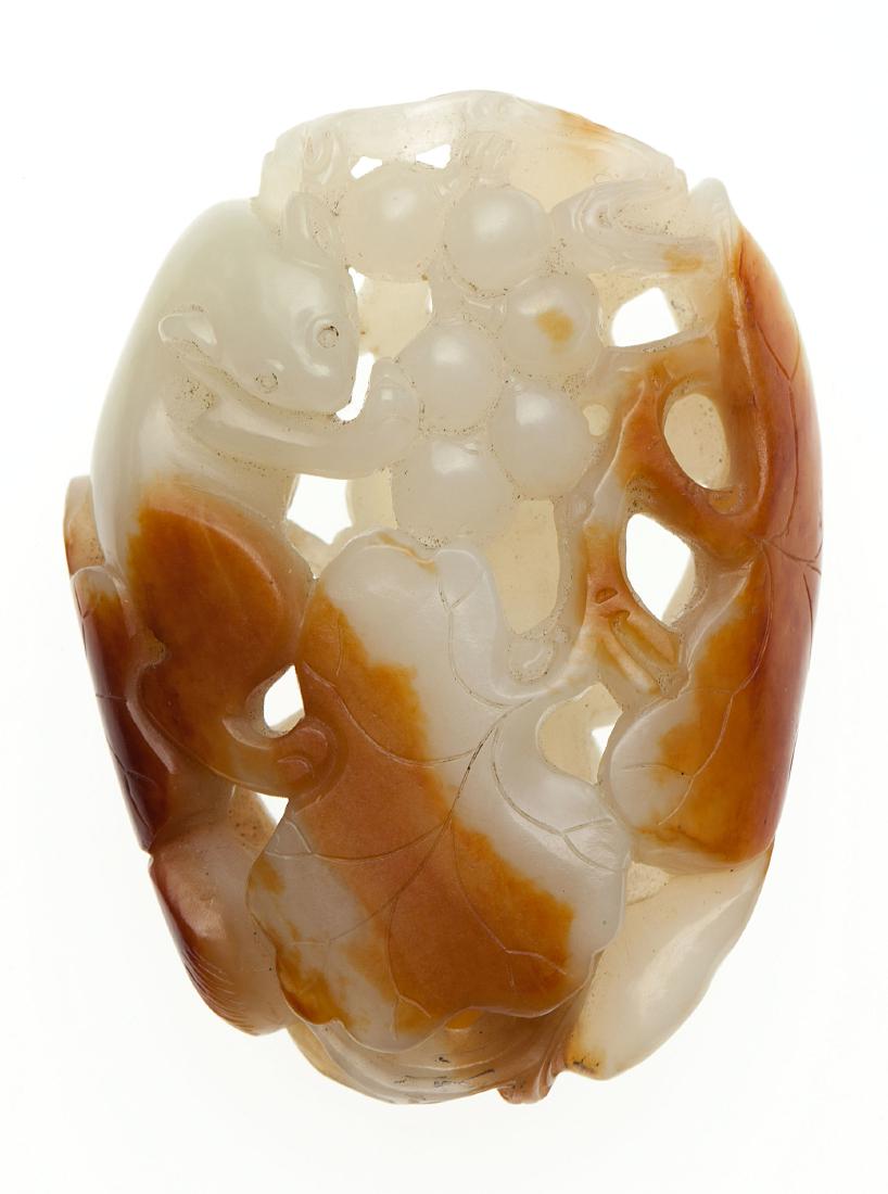 A Chinese white jade 'squirrel and grape' pendant (1 of 2)