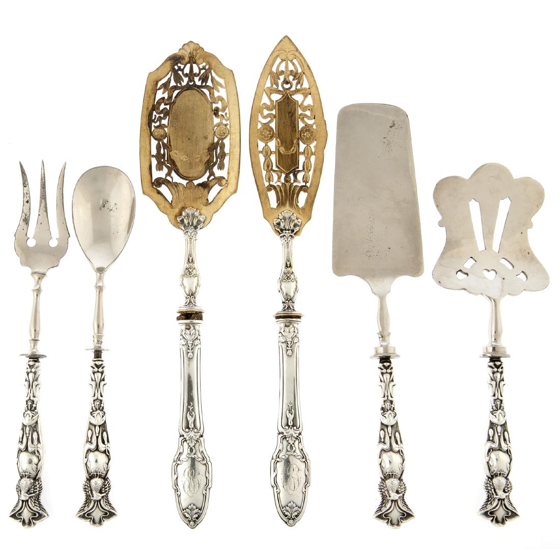 A group of continental flatware servers with silver (1 of 3)