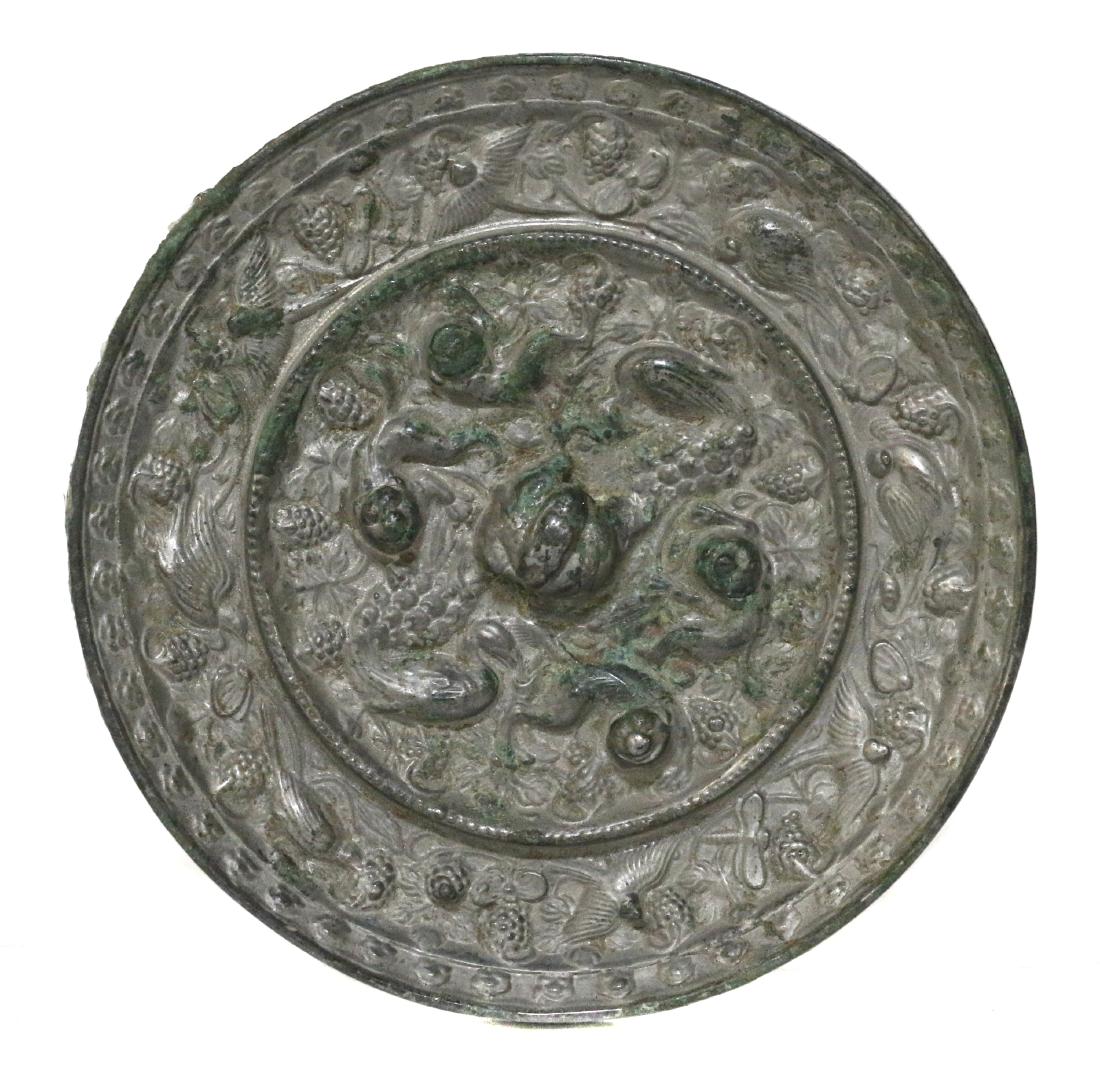 A Chinese bronze 'beasts and grapes' mirror (1 of 5)