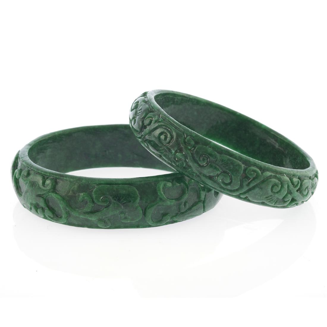 A collection of two carved jade bangle bracelets (1 of 6)