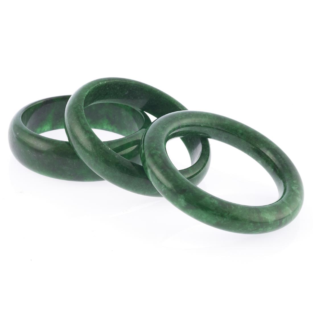 A collection of three jade bangle bracelets (1 of 5)