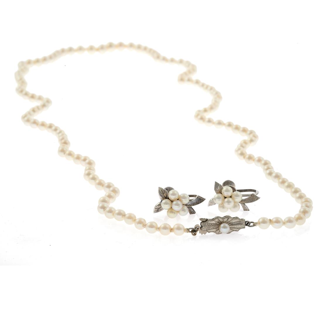 A cultured pearl necklace and pair of Mikimoto ear: Composed of one hundred twenty-nine round cultured pearls graduating from approximately 8.2 to 4.2 mm, completed by a white metal hook and box clasp accented by one round cultured pearl forming a