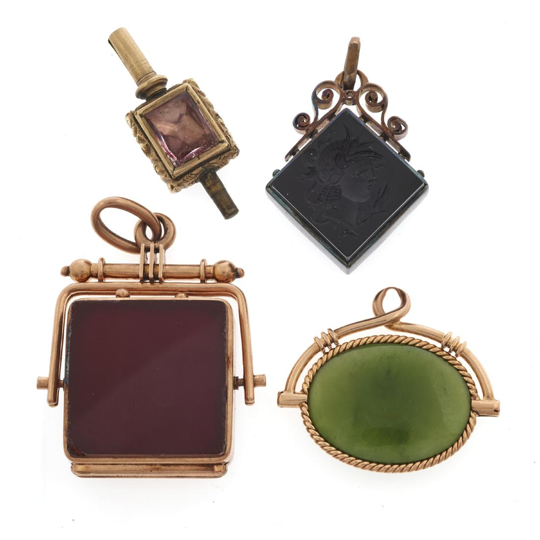 A collection of gold watch fobs and a watch key (1 of 3)