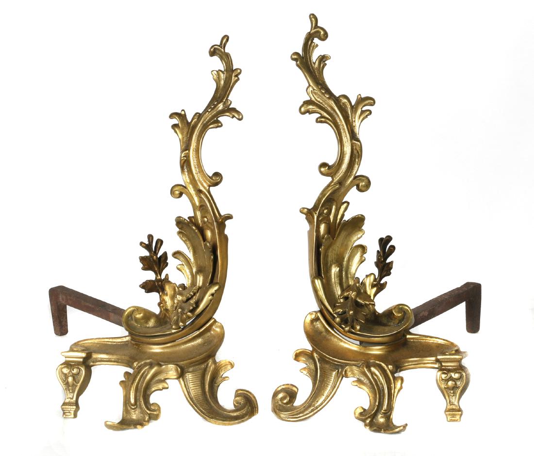 Pair of Rococo style gilt bronze chenets: The scrolling acanthus leaf rising on scrolled feet, 20 in. (51 cm.) high Condition: Overall good with age consistent wear and use. 