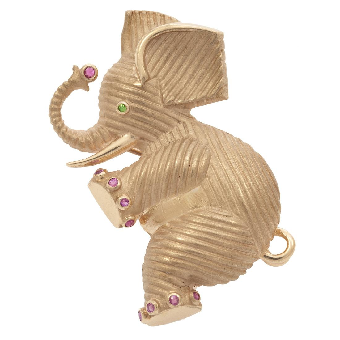 A pink sapphire, chrome diopside, 14k elephant pin: Designed as an elephant, featuring nine round-cut pink sapphires weighing a total of approximately 0.10 cttw. and one round-cut chrome diopside weighing approximately 0.01 ct, set in a textured pin mo