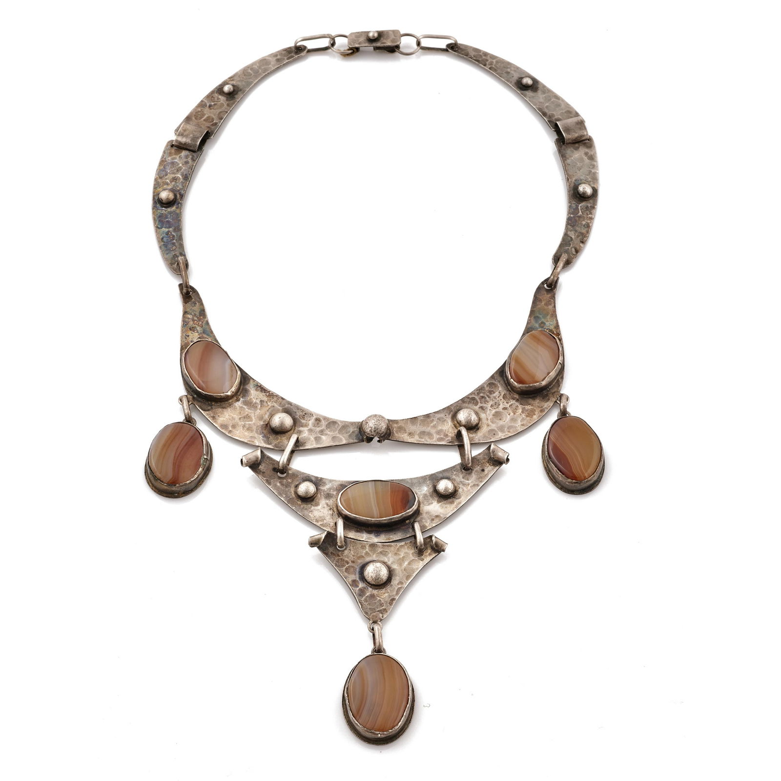 A Modernist agate, silver necklace: Featuring six oval agate cabochons ranging in size from approximately 24 x 18 mm to 22 x 14 mm, set in an articulated hammered silver necklace measuring approximately 11 1/4in. l x 5in. w. Signed H