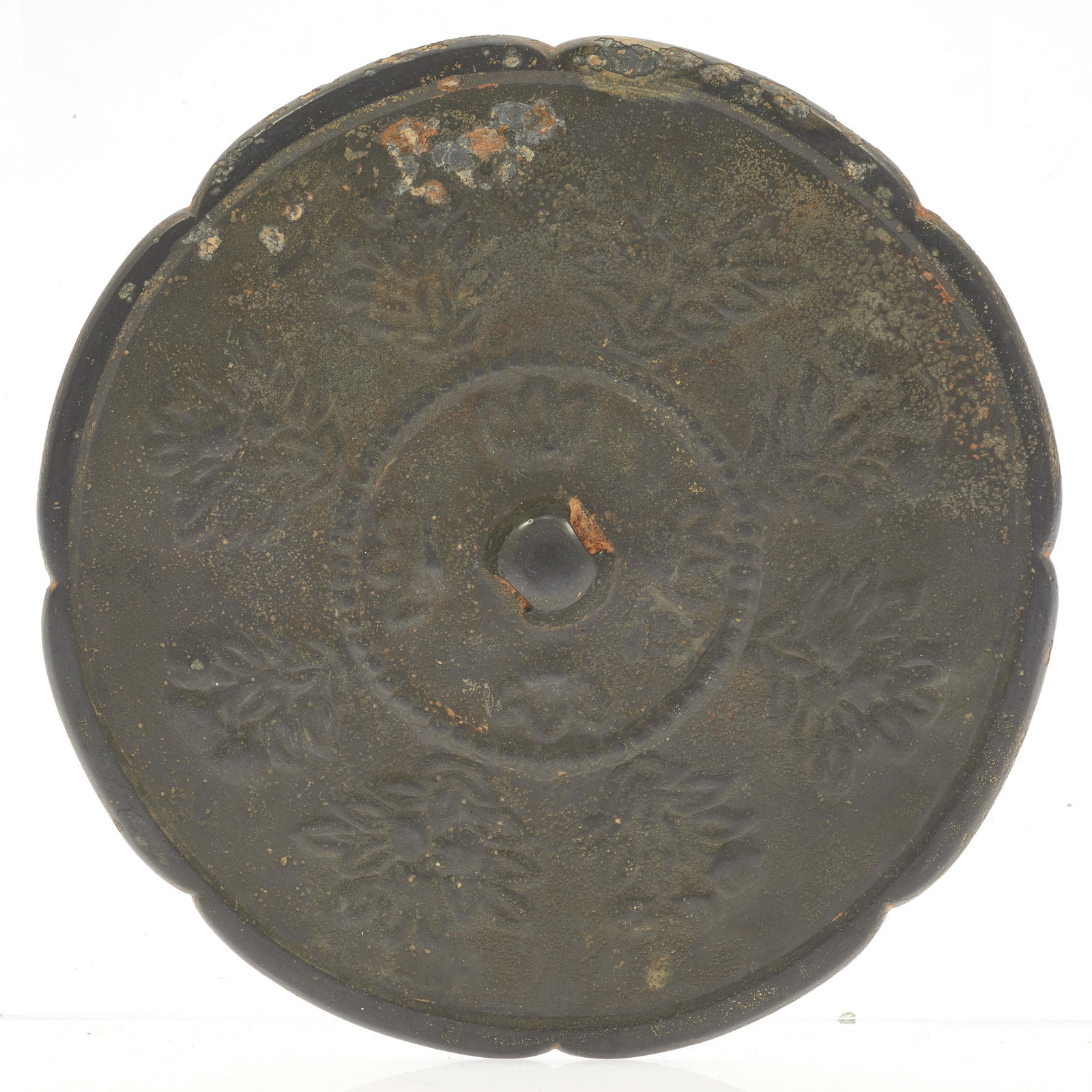 A Chinese bronze mirror: Cast with a foliate rim and a band of flowers enclosing additional flowers. Diameter: 6in.