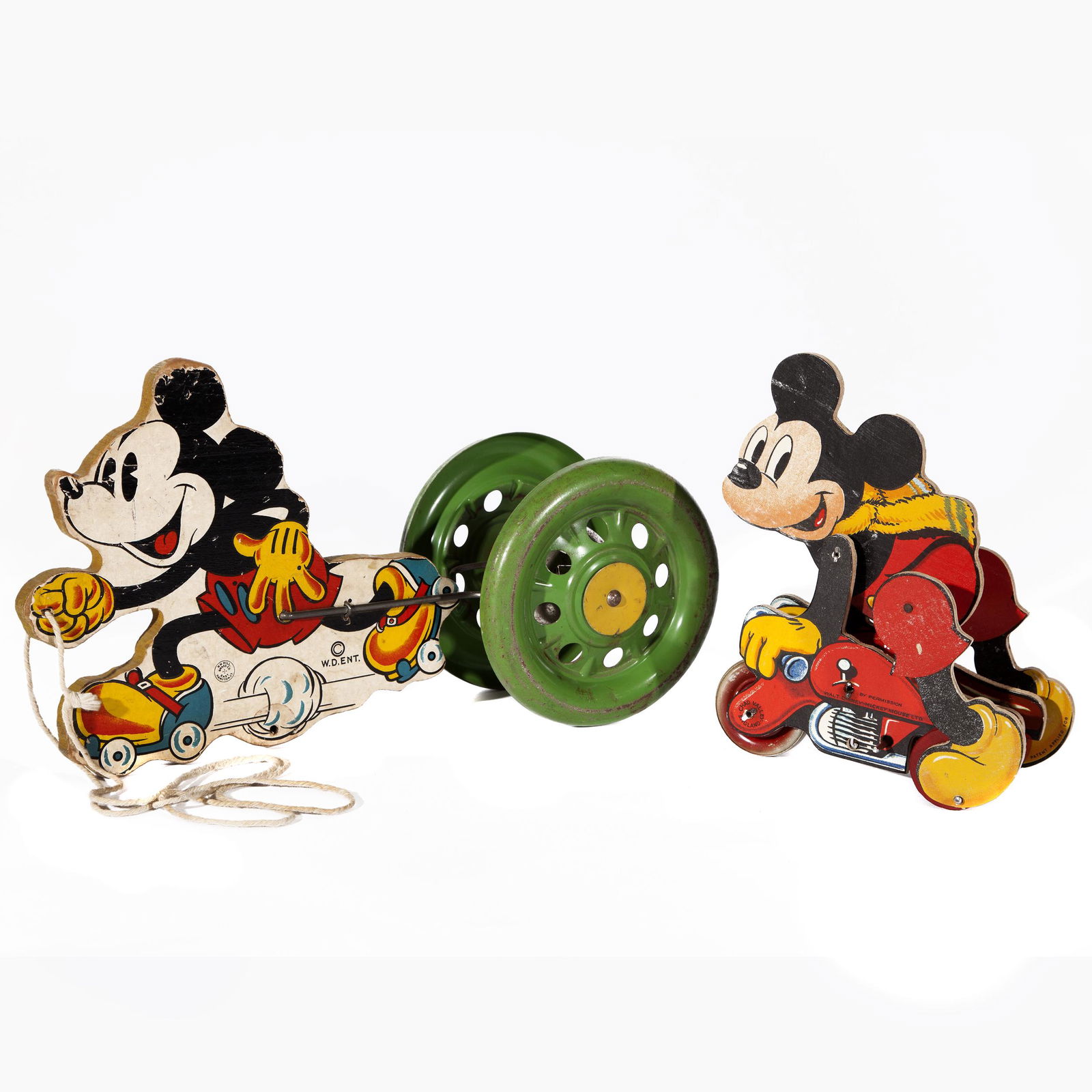 Mickey Mouse Wind Up and Wheel Toy (England and East: Two Mickey Mouse toys: Chad Valley England by Permission Walt Disney Mickey Mouse Ltd. and the larger green wheeled W.D. ENT., N.N. Hill Brass Co. East Hampton CT measures 12 1/2in. L xÂ 7in. H. it