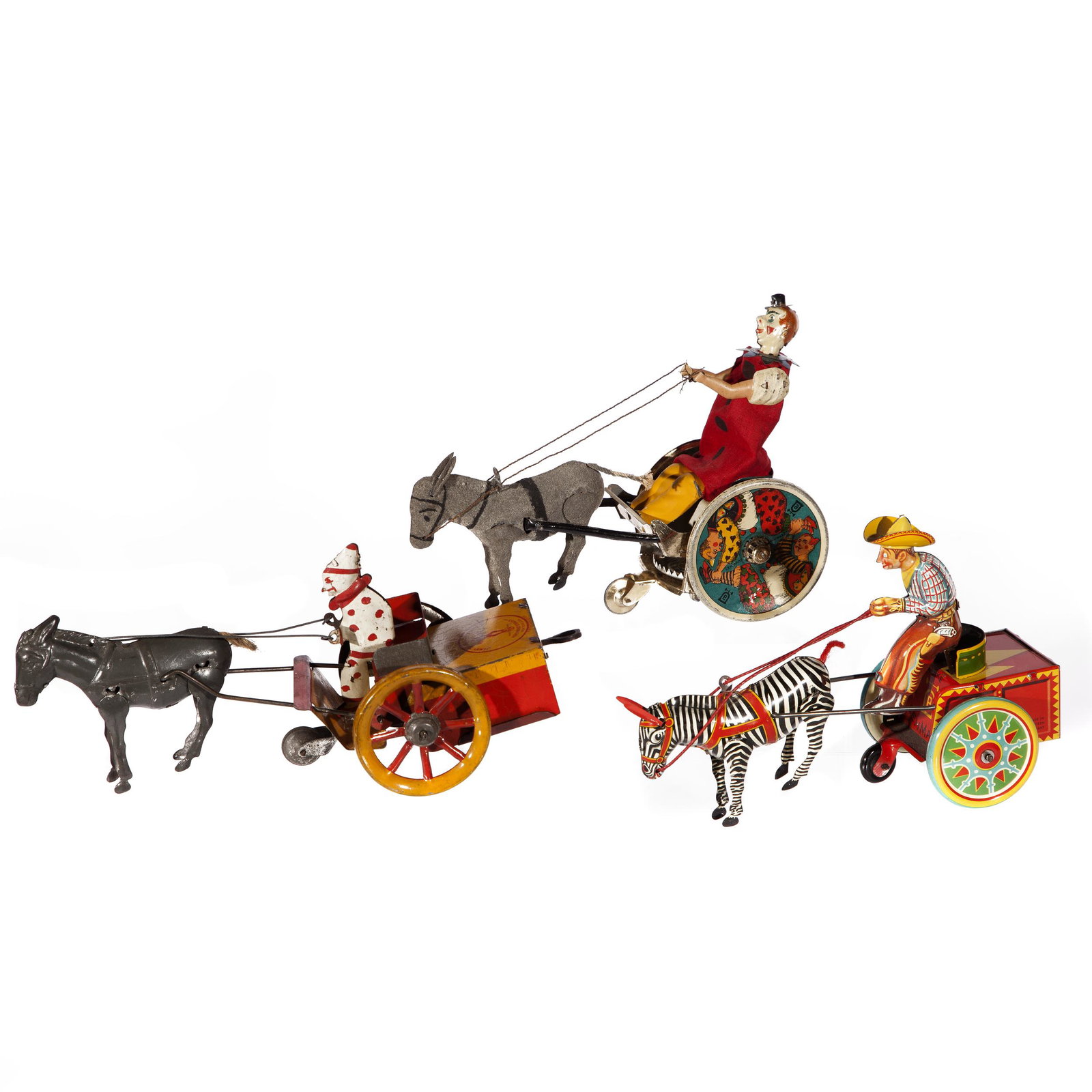 Three Cart Drawn Lehmann and Strauss Toys: Group of three pressed metal toys. A clown steers 'Jenny the Balking Mule' by Strauss Toys, New York, U.S.A.. Two others made by Lehmann. A Lehmann Pat. U.S.A. 22. Jan.07 made in Germany, and Lehmann 