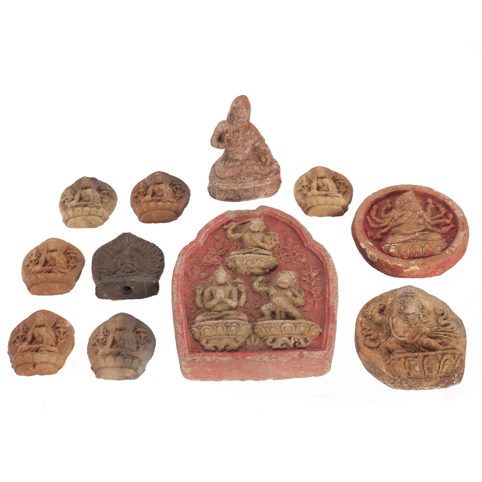 Group of Tibetan Buddhist Clay Ornaments, Qing Dynasty: Comprising ten small and miniature tsa-tsas, and a miniature figure of a llama. Tallest: 2 3/4 inches Condition: Small chips and wear.