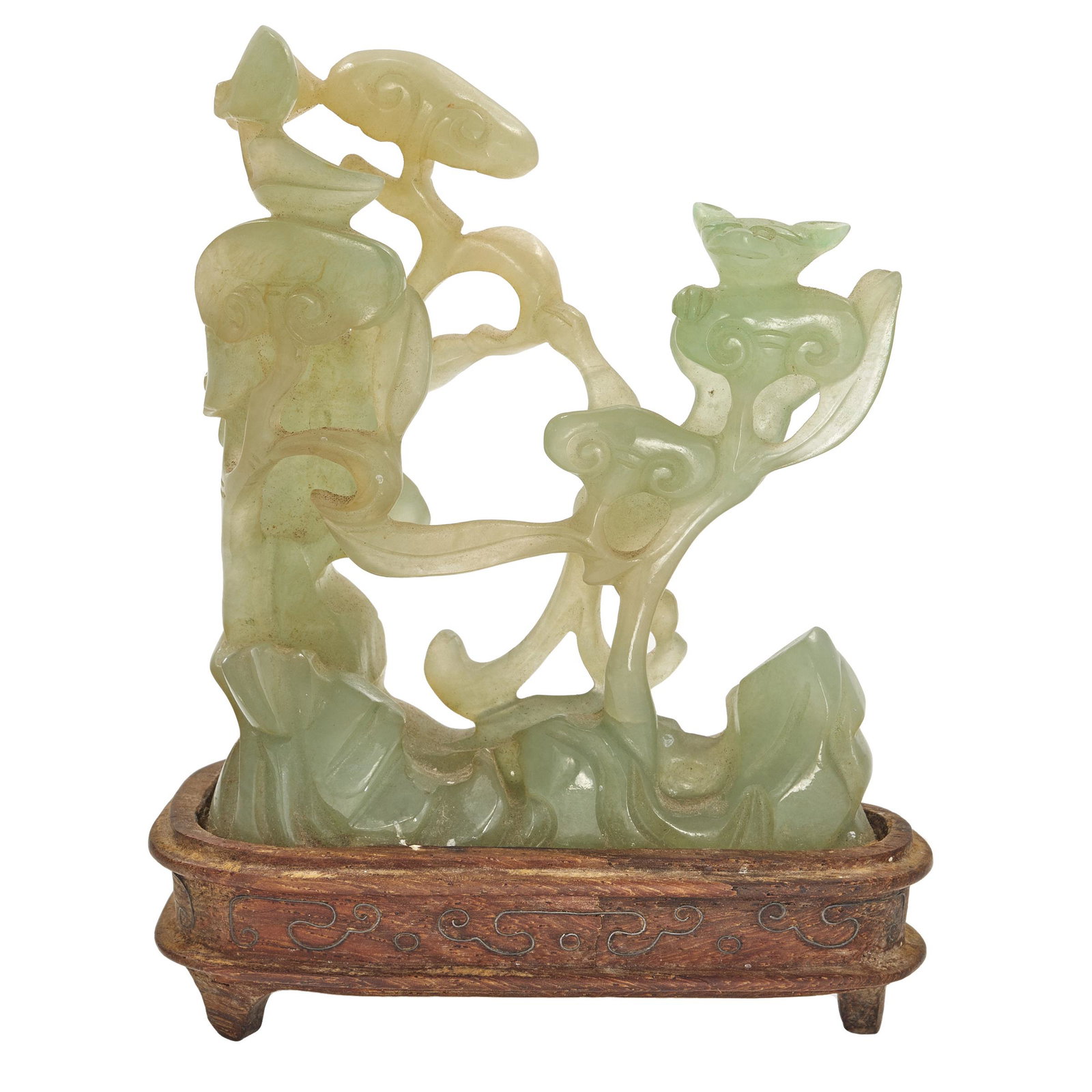 Jadeite Openwork Carving, 19th Century: Featuring a chilong dragon climbing lingzhi fungus branches and on top of rocky outcrop, the semi-translucent stone of a mint green hue, fitted wood stand with silver wire inlay. H: 3 1/8 inches Prove