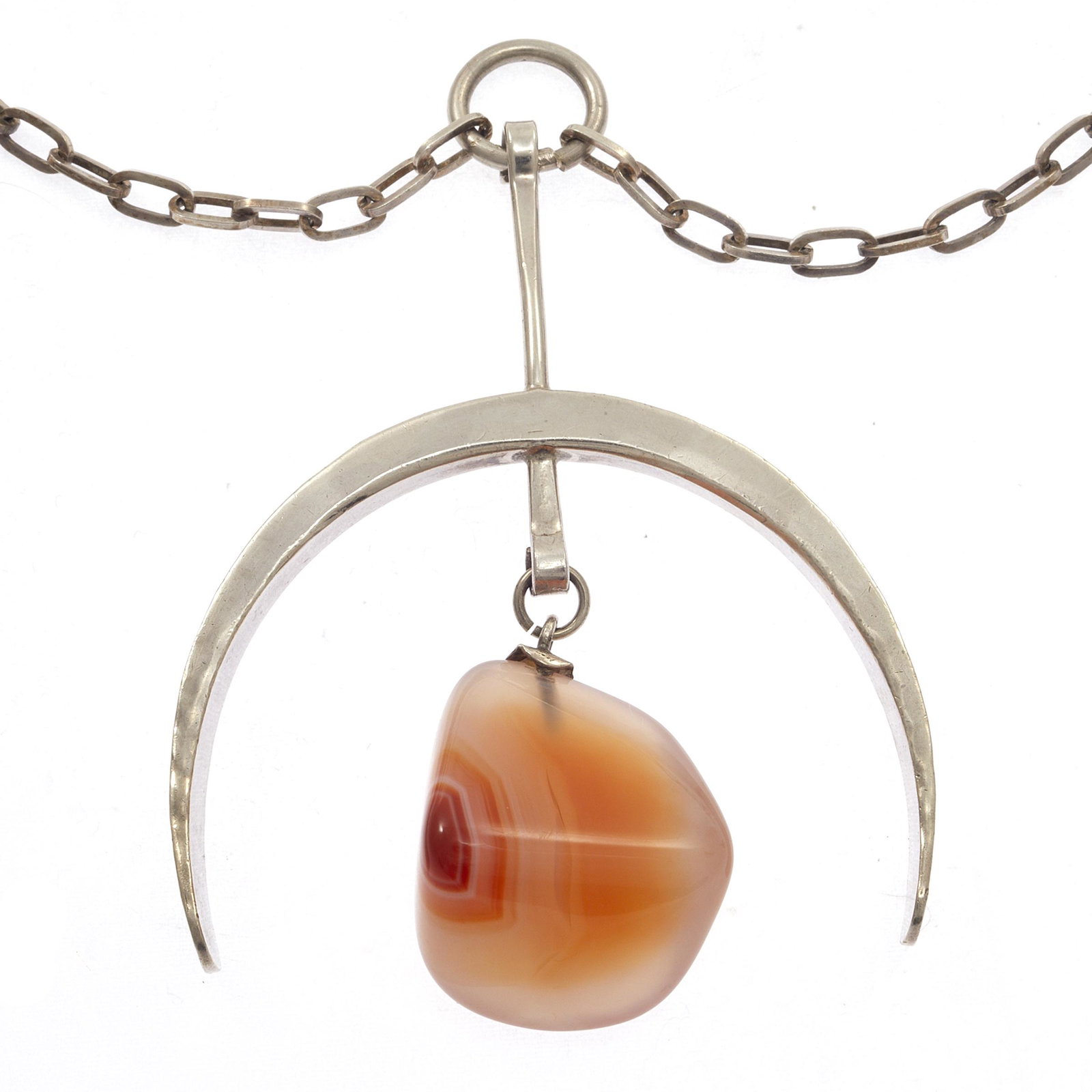 Modernist Norway PLUS Studio Agate, Sterling Necklace: Featuring a tumbled carnelian agate articulating from a curved hook pendant, suspended from a sterling silver cable link chain forming a 31 inch necklace. Gross weight: 48.9 grams. Note: PLUS Studio