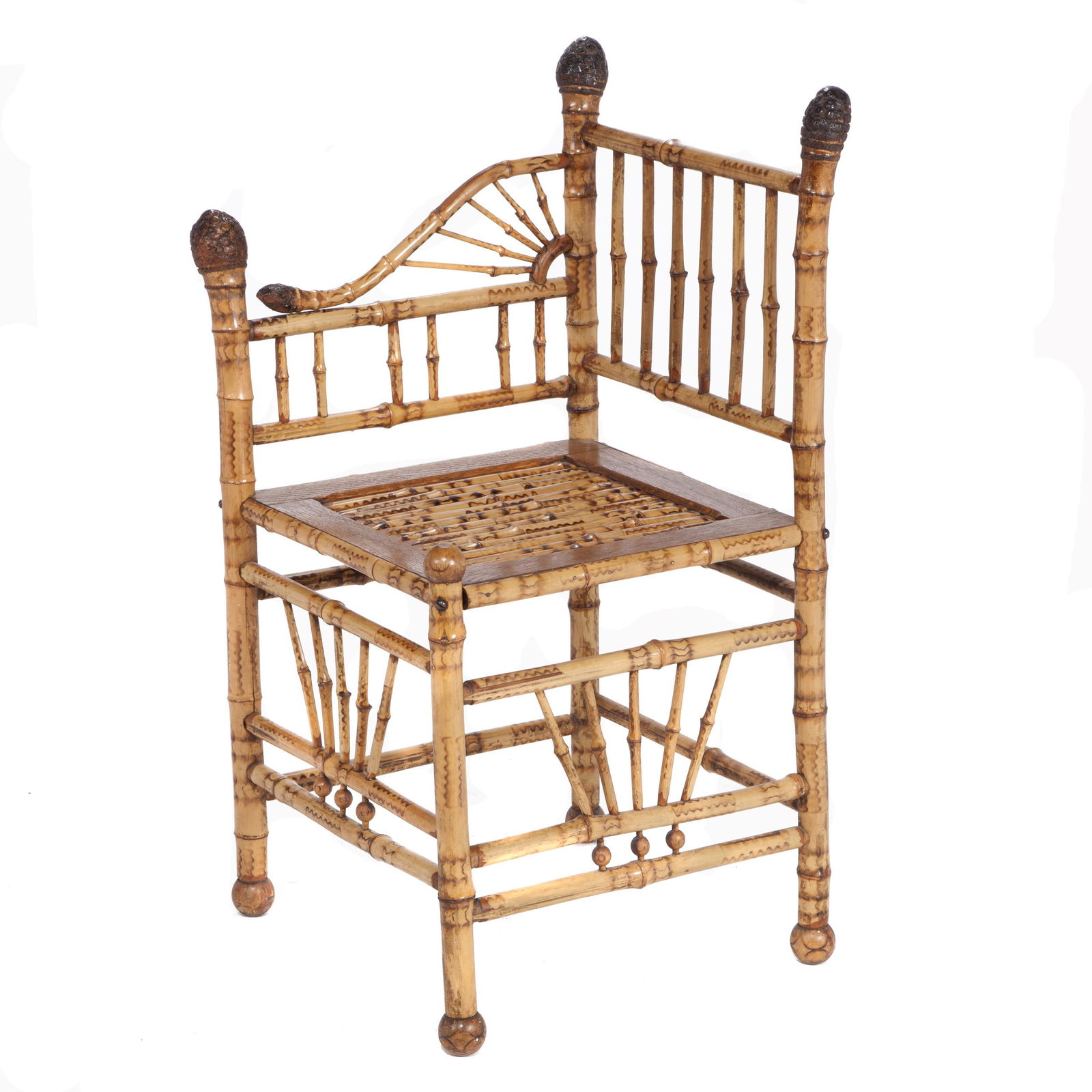 Victorian Bamboo Corner Chair: The bamboo stiles with pod finials, one arm carved as a whimsical snake, raised on turned legs. 33in. (84cm) h. 16in. (41cm) w. 16in. (41cm) l.