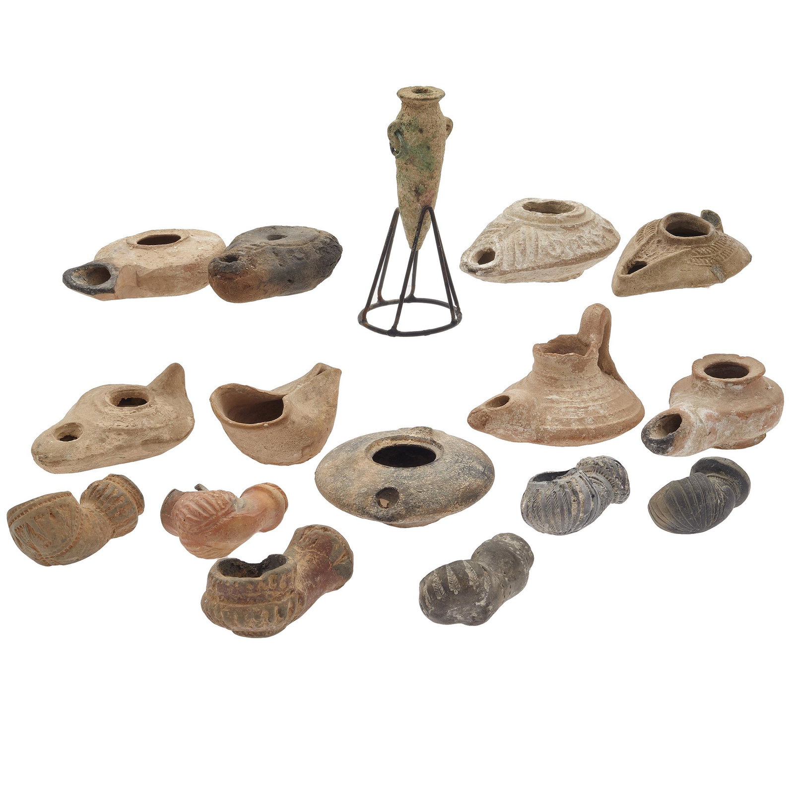 Group of Roman, Helenistic, and Byzantine Ceramic Oil: A collection of sixteen clay lamps, several with incised decoration, one with ancient (Greek?) letters. largest 4in. (10cm) l. all with wear as expected for age and use.