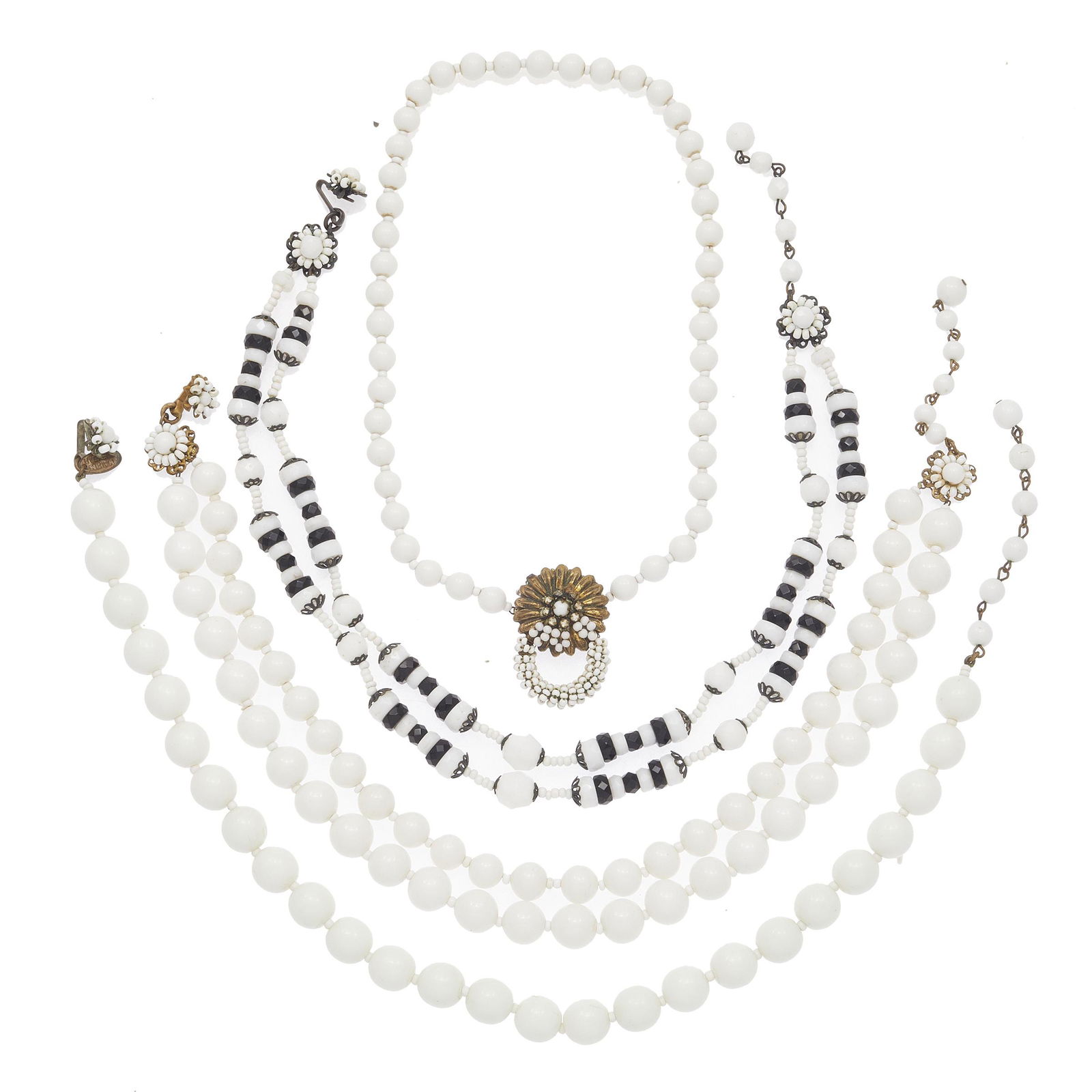 Collection of Four Miriam Haskell Necklaces: Including one double strand white glass bead necklace measuring 14 inches with extender; one white glass bead necklace with gold tone clasp designed as a flower, 16 inches; one single strand white gla