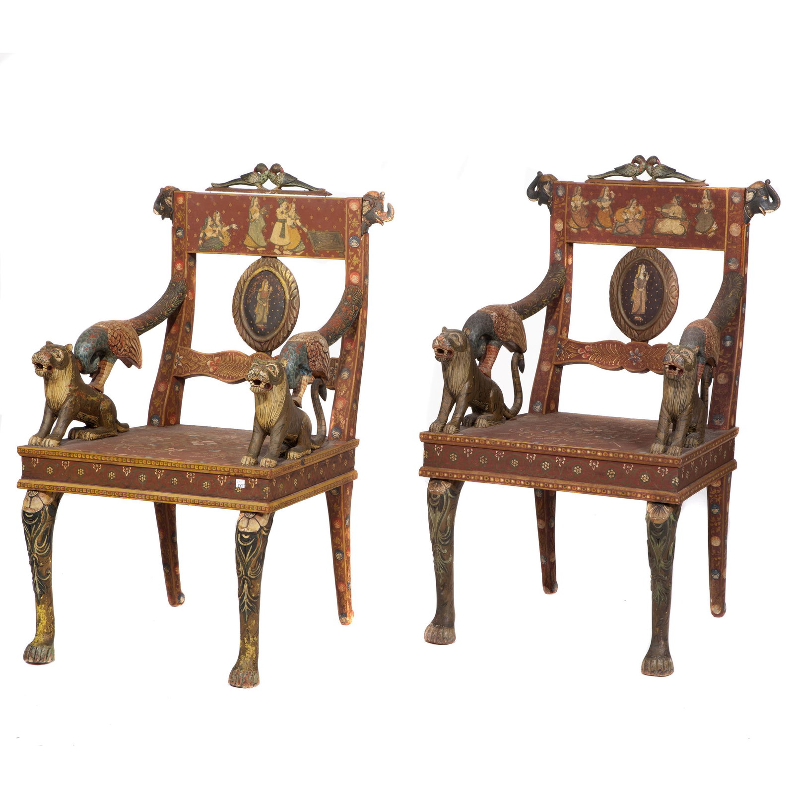 Pair Vintage Polychrome Decorated Indian Armchairs: Each crest carved with a pair of parrots over floral and figurative painted back and seat, the swept arms terminating in a parrot perched upon a tiger. 39in. (99cm) h. 23in. (58cm) w. 20in. (51cm) d #