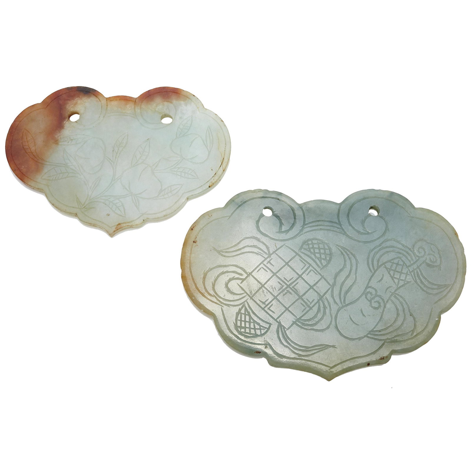 Two Jadeite Pendants: Both carved in the form of a ruyi head and incise decorated with various auspicious objects, featuring two drilled holes for suspension. Width: 4 1/8 and 3 7/16 inches Condition: Some small chips. #Ja