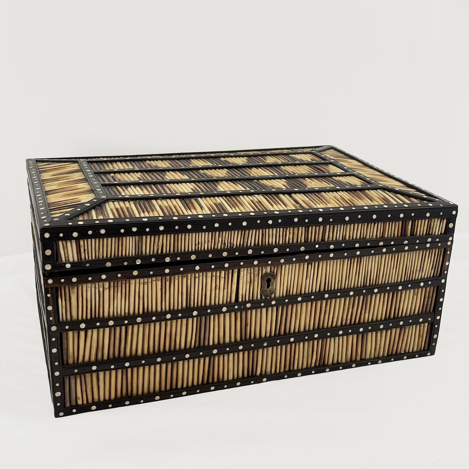 Quill, Ebony and Bone Work Box, Ceylon: Ceylon, Galle District, Circa 1850. The lid interior decorated in bone inlay depicting Ceylonese Devil Dancing above a fitted lift out tray. 6 1/2in. (17cm) h. 15in. (38cm) l. 10in (25cm) d. Condition