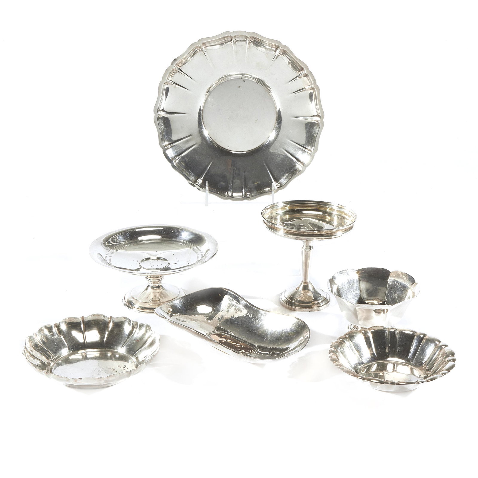 Collection of Arts & Crafts and Neoclassical Sterling Table Ware: Comprising; A hammered sterling and copper bowl 8 1/2in (21cm) l. Stamped VR. 228.5 grams A tazza 3in. (8cm) h. 7in. (18cm) d. 294.0 grams A Revere style bowl 2 1/2in (6cm) h. 5in. (13cm) d. 133.1 gra