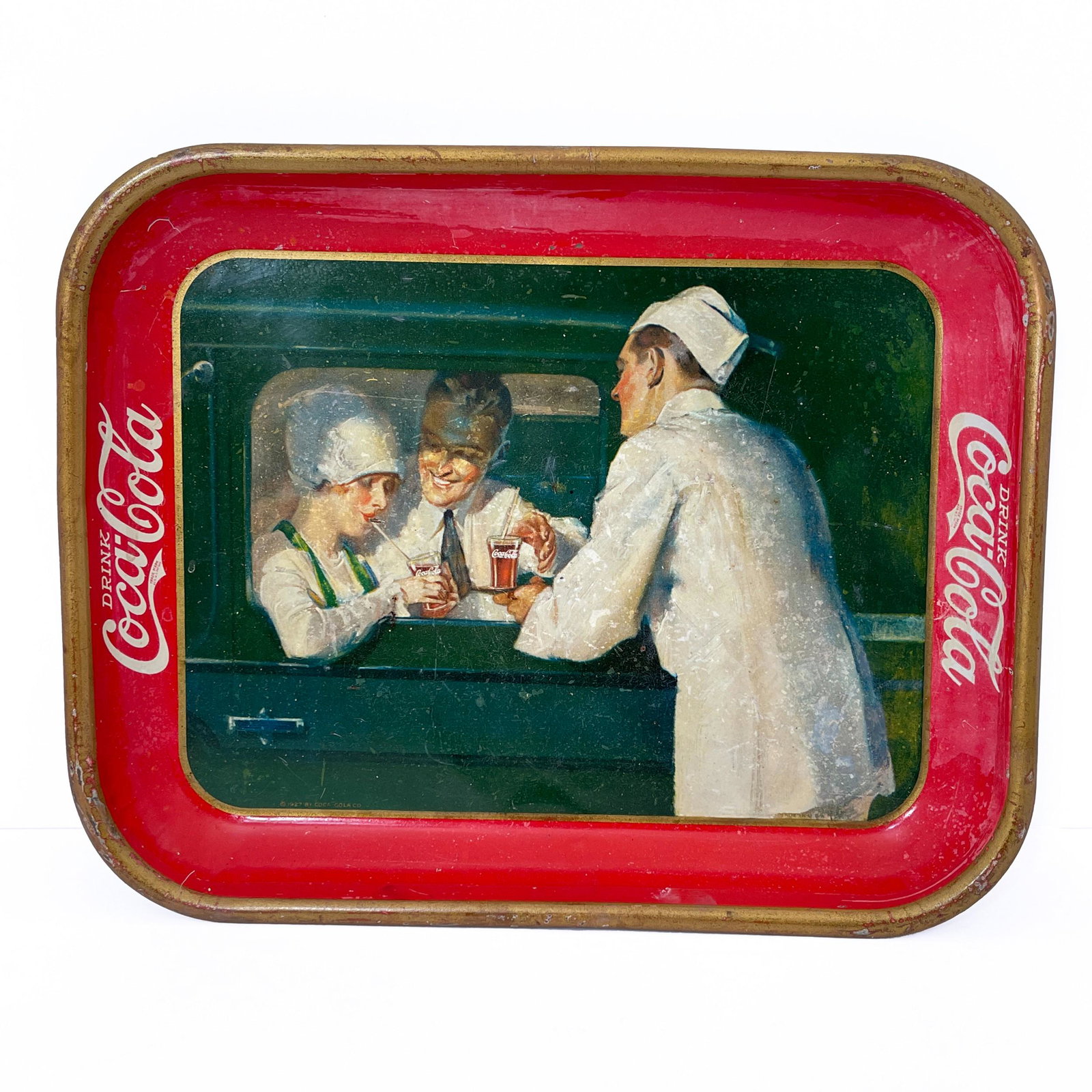 Vintage Coca-Cola Curb Service Tray, Charming rectangular tin tray with printed illustration showing: Vintage Coca-Cola Curb Service TrayCharming rectangular tin tray with printed illustration showing a man and a woman seated in a car being served glasses of Coca-Cola, the border with white lettering 