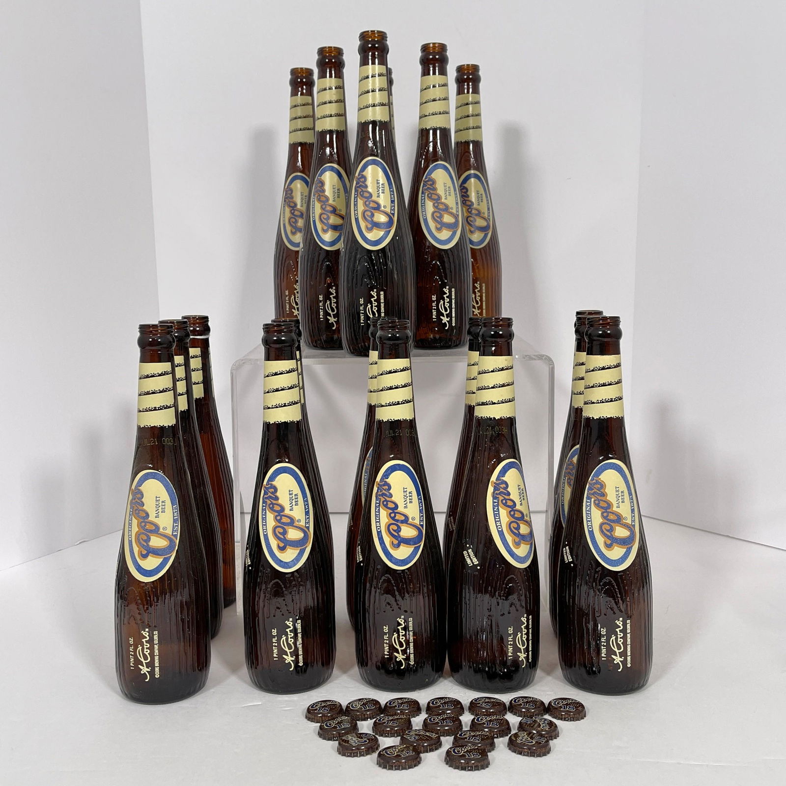 Eighteen Limited Edition Coors Bat Bottles, Eighteen 18oz Coors "Banquet Beer" Bottles styled as: Eighteen Limited Edition Coors Bat BottlesEighteen 18oz Coors "Banquet Beer" Bottles styled as baseball bats, with eighteen corresponding loose caps. In two original illustrated cardboard display boxe
