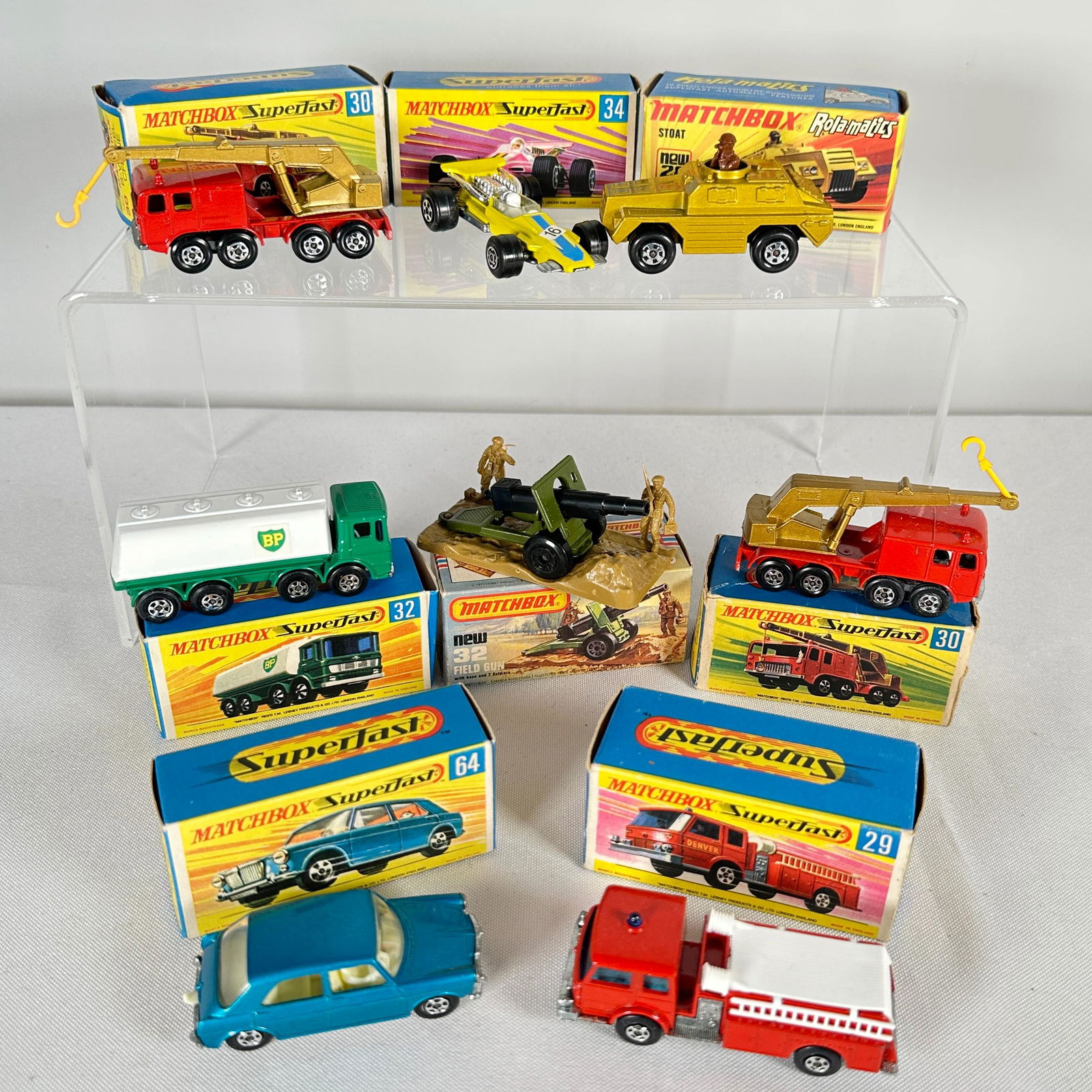 Group Of Nine Matchbox Superfast Vehicles: Group Of Nine Matchbox Superfast VehiclesIncluding: 28 Mack Dump Truck, pea green body, green windows, metal baseplate, large plastic wheels; 28 Stoat, metallic gold body, brown observer figure, black