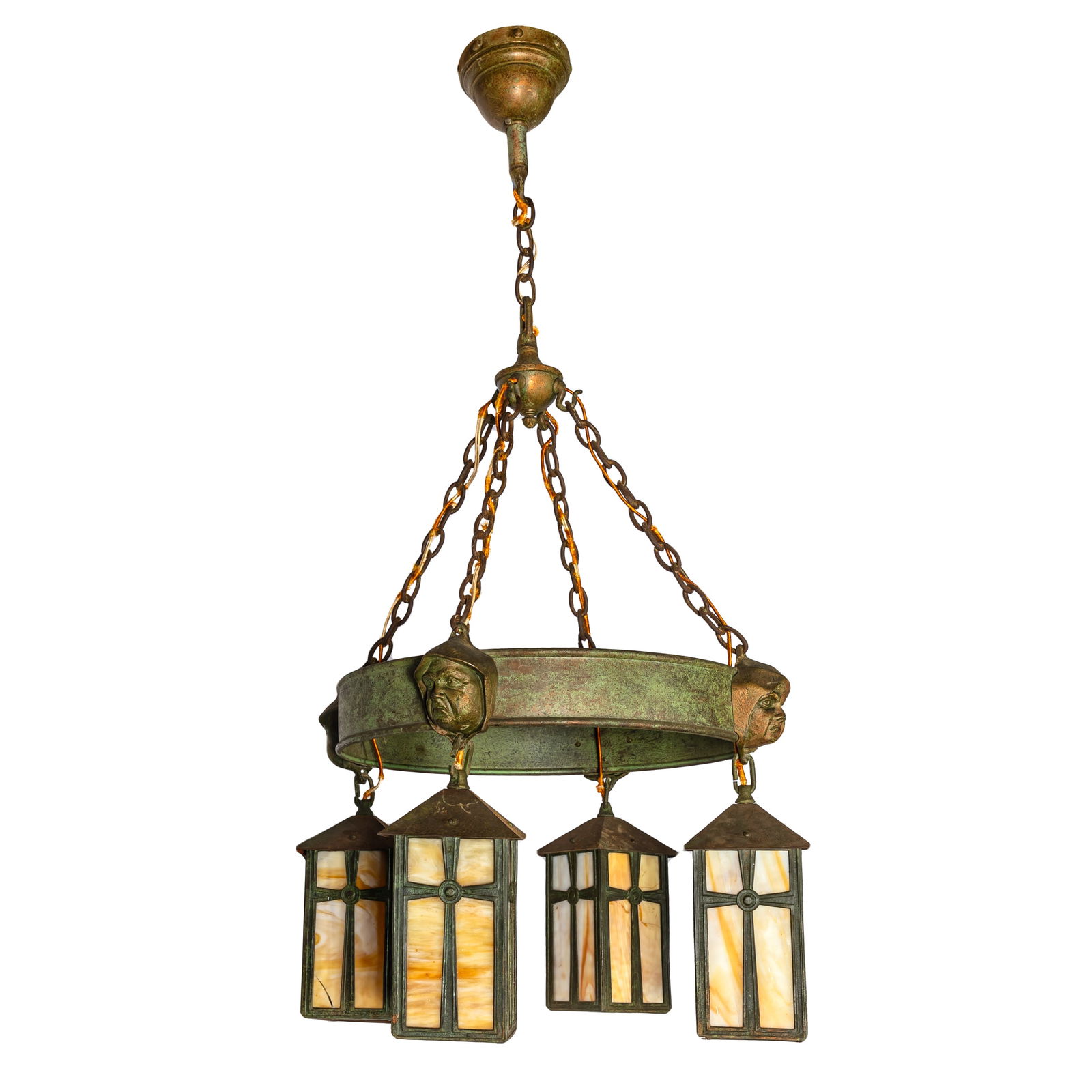 Arts and Crafts Wrought Iron Chandelier: Arts and Crafts Wrought Iron ChandelierThe circular corona set with scowling monks, judging the 'Seven Deadly Sins' suspending four slag glass lanterns.38in. (96cm) h. 17in. (43cm) d.
