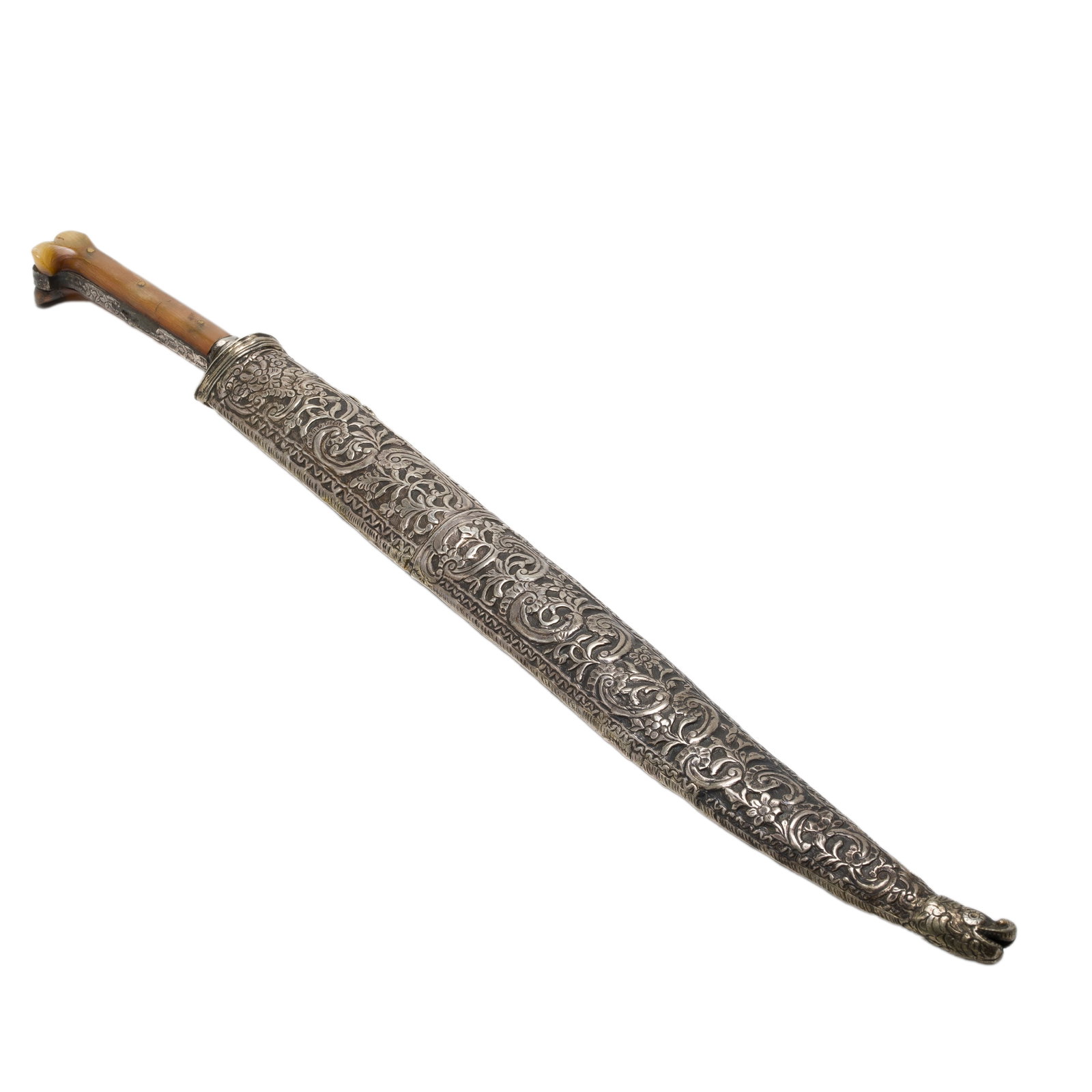 Turkish Knife, circa 1890: Turkish Knife, circa 1890 Turkish knife having a silver scabbard with allover scrollwork design, horn hilt with engraved grip strap and bolster, the single edge blade with feather mantinada and uniden